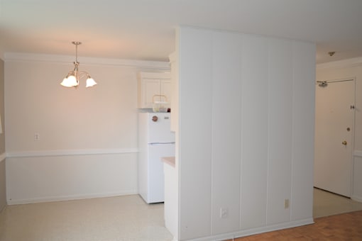 View from hallway to kitchen and living room with tile and parquet flooring at 359 Edison.