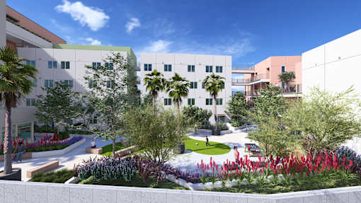 A modern building with a green roof and a garden in front.