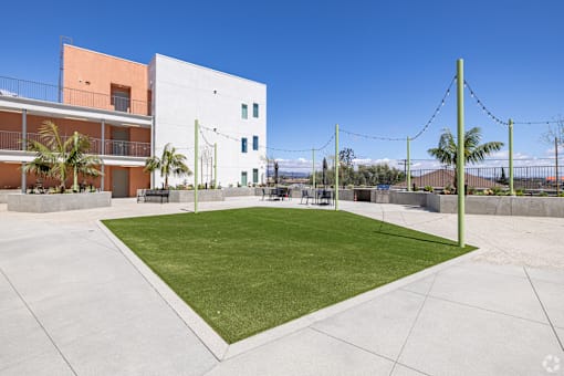 A modern building with a green lawn in front.