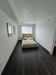 A long hallway with a bed on the floor.