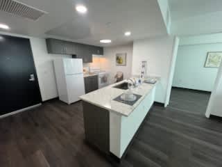 A kitchen with a white island and a sink.