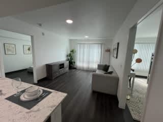 A living room with a couch and a television.
