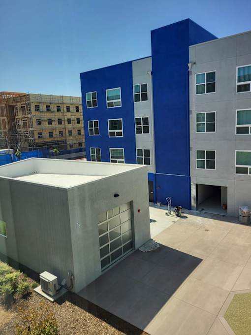 A modern building with a blue and white exterior is shown.