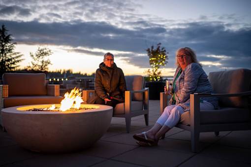 residents at fire pit at Harbor Heights 55+ Community, Washington, 98501