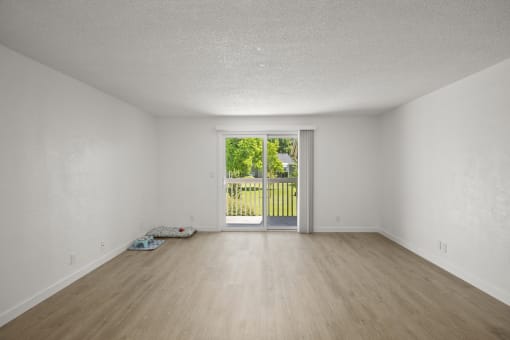 an empty living room with a door leading to a yard at Chalet, Springfield, Oregon