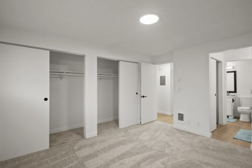 a bedroom with a carpeted floor and white walls at Chalet, Springfield, Oregon