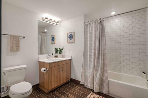 A bathroom with a toilet, sink, and shower.