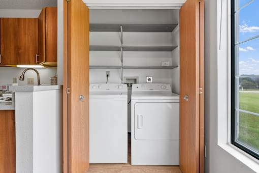 A small kitchen with a washer and dryer in it.