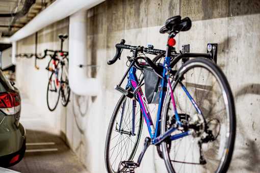 Underground parking lot at the modern apartment complex, featuring state-of-the-art electric vehicle chargers and bike racks for each assigned parking spot. A well-lit and spacious area with designated charging stations, ensuring convenience for residents with electric cars.