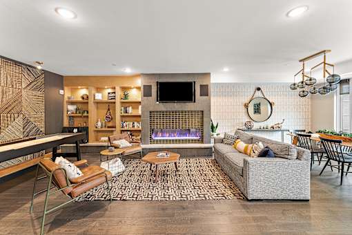 A modern living room with a fireplace and a television.