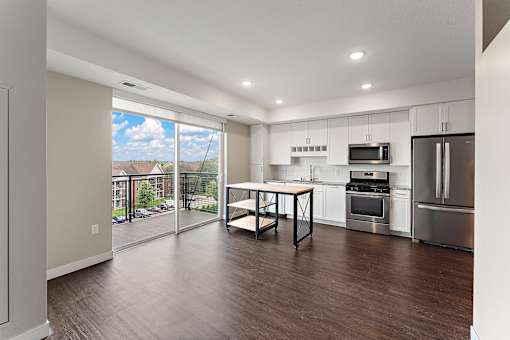 A modern kitchen with a dining table and chairs.