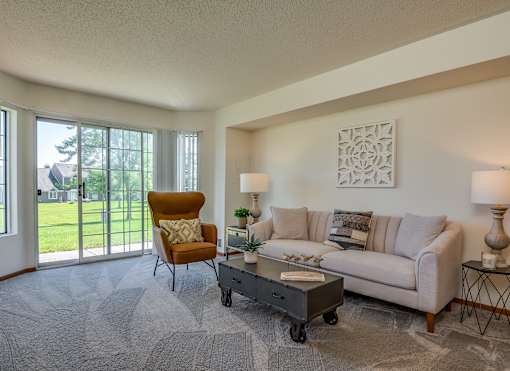 the living room of an apartment with a couch and a coffee table