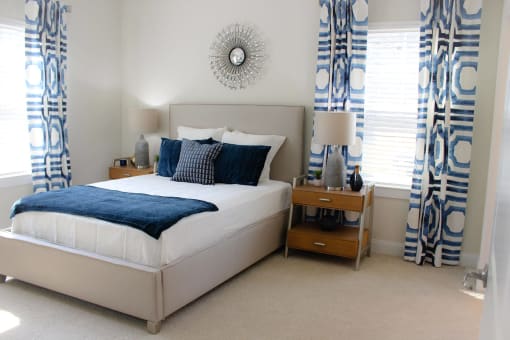 Bedroom with cozy bed at The Retreat at Fuquay-Varina Apartments, North Carolina