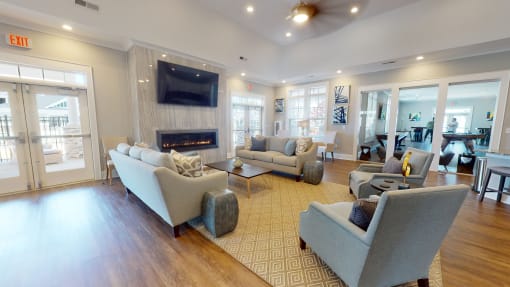 a living room filled with furniture and a flat screen tv at The Retreat at Fuquay-Varina Apartments, Fuquay-Varina