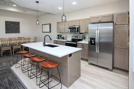 A modern kitchen with a bar stool.