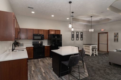 a kitchen and living room with a table and chairs