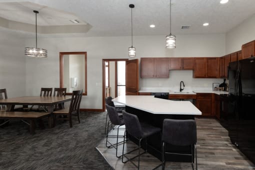 a kitchen and dining room with a table and chairs