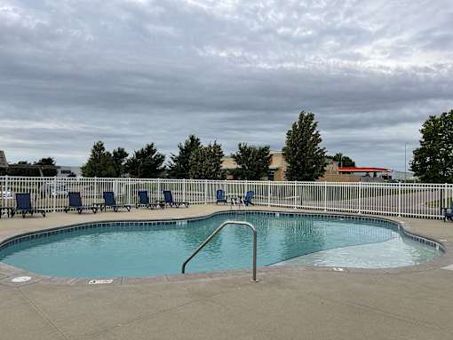 A small pool with a metal fence around it.