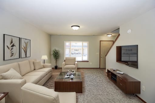 A living room with a couch, chair, and coffee table.