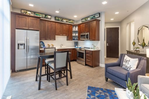 a kitchen and living room with a table and chairs