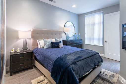 a bedroom with a bed and a dresser