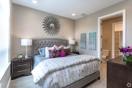 a bedroom with a bed and a mirror