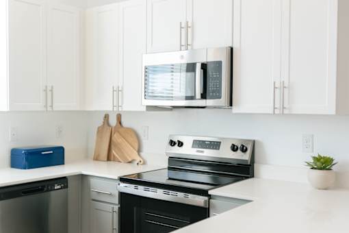 Stainless Steel Appliances at Avilla Vista Norte, Phoenix, AZ 85087A modern kitchen with a stove, oven, and microwave.