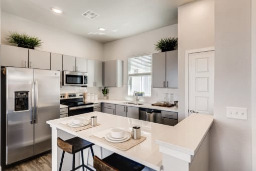 Fitted Kitchen With Island Dining at Avilla Buffalo Run, Colorado, 80022