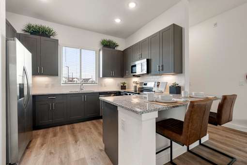 Gourmet Kitchen with Island at Avilla Rio Oaks Apartments, Liberty Hill, TX 78642