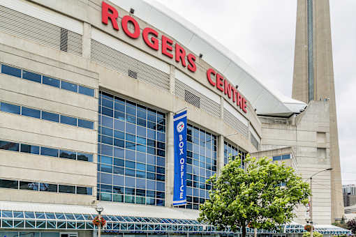 Rogers Centre is a large building with a sign on the top.