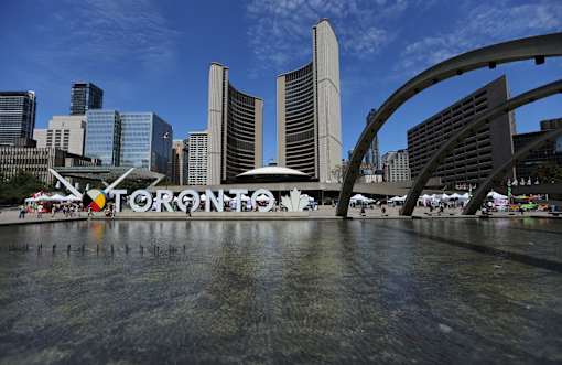 A view of a cityscape with the word "TORONTO" spelled out in large letters.