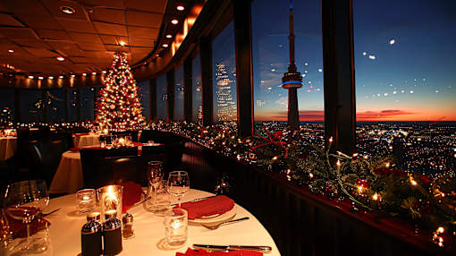 A restaurant with a view of the CN Tower at night.