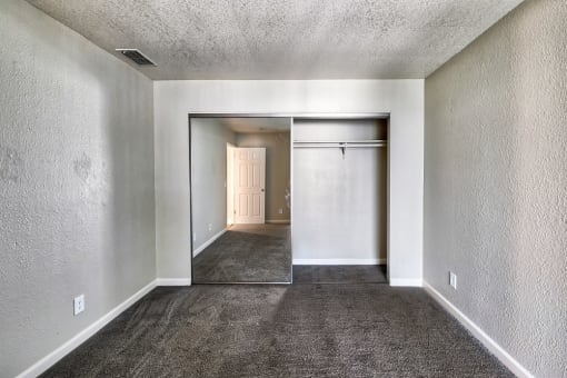 an empty room with a carpeted floor