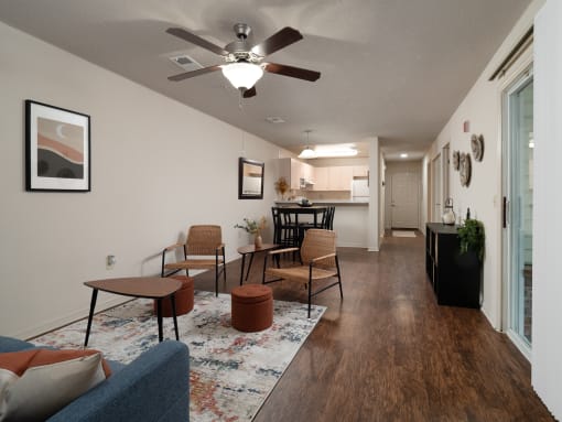 the view of a living room with a ceiling fan and a kitchen at The Fountains Apartments, Florida, 32514