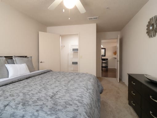 a bedroom with a large bed and a view of a bathroom and a closet at The Fountains Apartments, Pensacola, Florida
