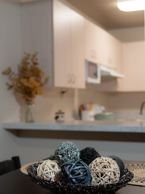 a bowl of balls on a table in a kitchen at The Fountains Apartments, Pensacola, 32514
