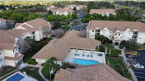 a aerial view of a swimming pool in a neighborhood of houses at Tivoli Apartments of Orlando, Oviedo, FL