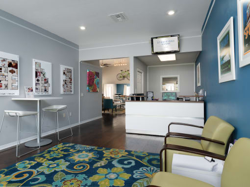 a leasing office with blue walls and a blue rug and a reception desk at Stoneridge Apartments, Gainesville, Florida, 32608