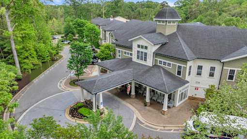 A large house with a gazebo-like structure in the front yard.