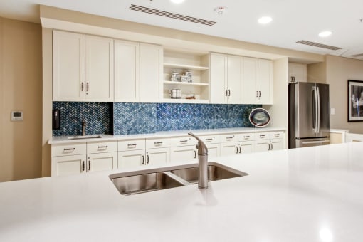 A kitchen with a sink and a refrigerator at White Springs Senior Living, Warrenton, 20186