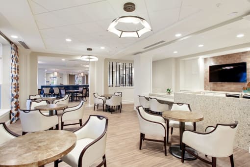 A white room with tables and chairs at White Springs Senior Living, Warrenton, Virginia