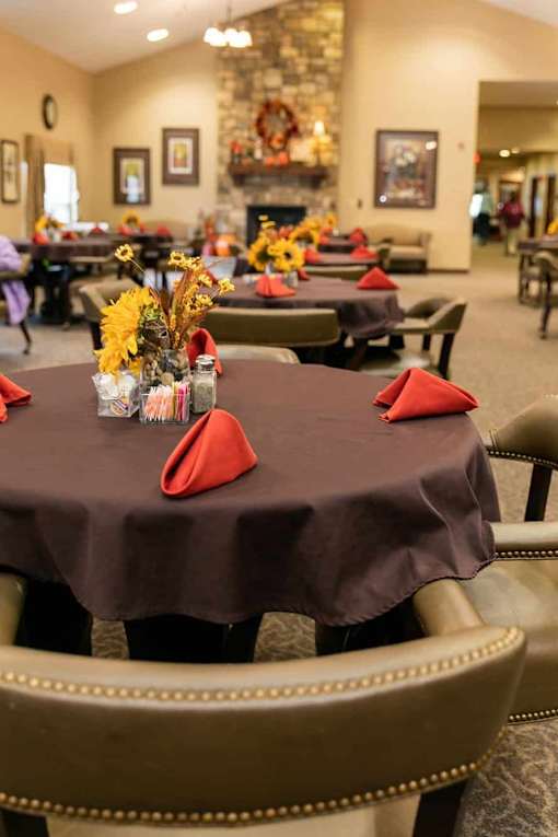 A dining room with tables set for a meal.