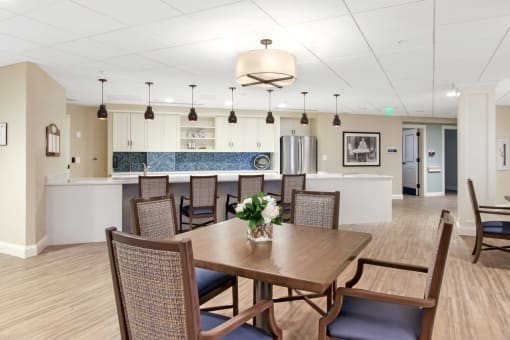A dining room with a table set for six at White Springs Senior Living, Warrenton