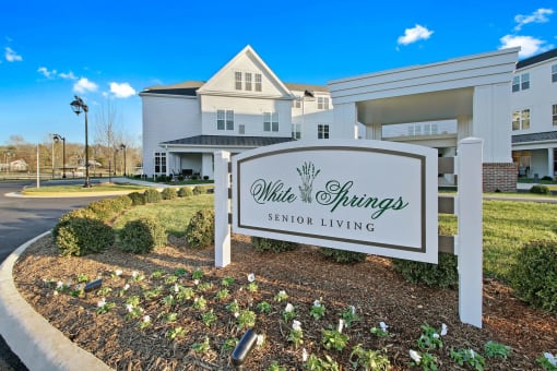 A sign for White Springs Senior Living in front of a building at White Springs Senior Living, Virginia 20186