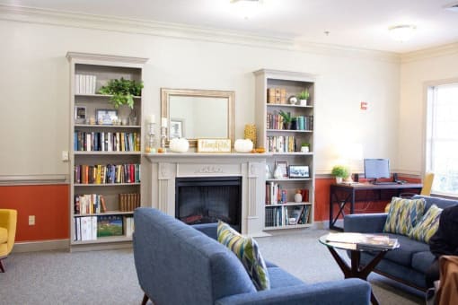 Living room filled with furniture and a fireplace at Spring Arbor of Crofton, Crofton