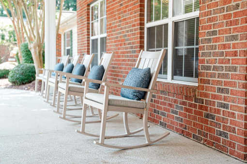 Row of rocking chairs at Spring Arbor of Kinston in Kinston, NC