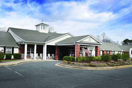 A building with a white cupola on top of it.