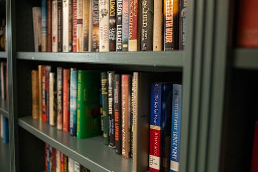 A bookshelf filled with various books of different sizes and colors.at Spring Arbor of Williamsburg, Williamsburg, VA, 23185