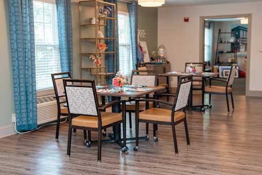 A dining room with a table and chairs.