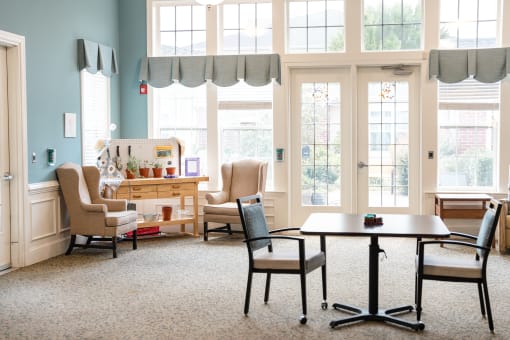 Living room with a table and chairs Spring Arbor of Cary
